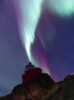 The northern lights above the lighthouse tower.