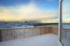 Snow-covered veranda with view to the sea.