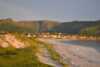 Beach with village and mounteins in the back.