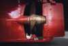 A girl sitting under the propeller on MS Finnmarken, reading a book.