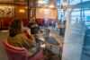 Adults enjoying a cup of coffee in MS Finnmarken.